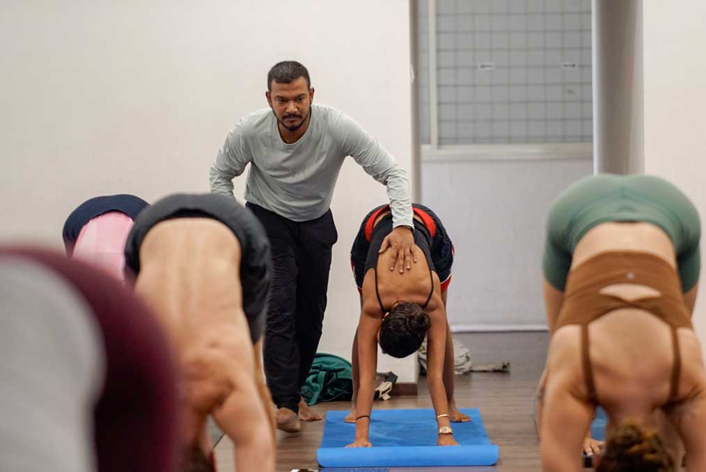 Hands-on adjustment during a backbend in the practice hall